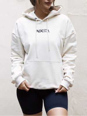 nikita cream white ecru sand hoodie oversized with line drawing logo empowering quote quality jumper airport outfit drawstring hoody