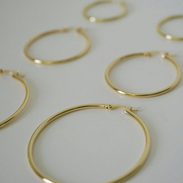 NIKITA classic, every day hoop earrings. Waterproof and hypoallergenic 18k plated hoops with a stainless steel base. Everyday jewellery gift for her.