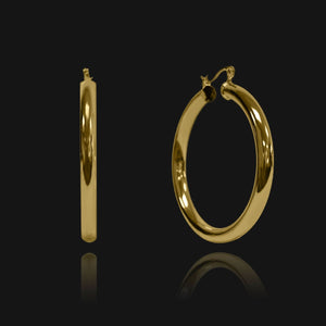 NIKITA Lexi large thick hoop statement earrings with an 18k gold plated finish. Hoops for women made with a quality water-resistant, hypoallergenic stainless steel base. Christmas everyday jewellery gift for her.