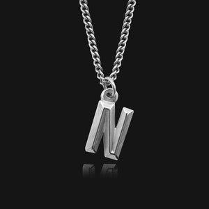 NIKITA custom initial pendant necklace with a unique, personalised letter design. A water-resistant silver pendant and adjustable chain made with a hypoallergenic stainless steel base. Christmas everyday jewellery gift for her.