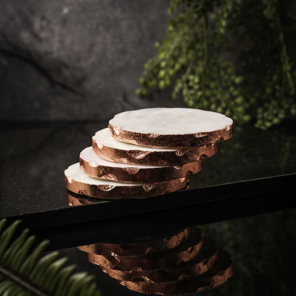 NIKITA solid marble coaster set of 4 to use for mugs and glasses in your home. A coffee table accessory with a gold, silver or rose gold leaf edge. Ideal christmas or new home gift for couples.