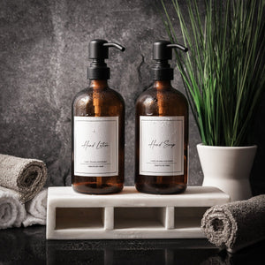 NIKITA amber glass dispenser bottle set with stainless steel pumps for your kitchen or bathroom. Durable soap dispensers with waterproof labels for hand soap, dish soap, hand lotion or hand sanitiser.