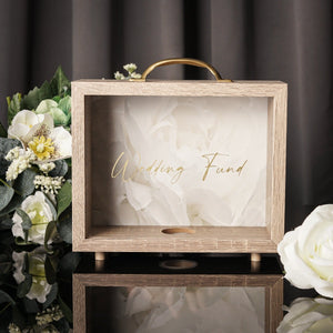 NIKITA wedding photo fund money box. An adult piggy bank to help couples with wedding savings. An adult piggy bank with italic text and a white floral background. Engagement gift for couples.