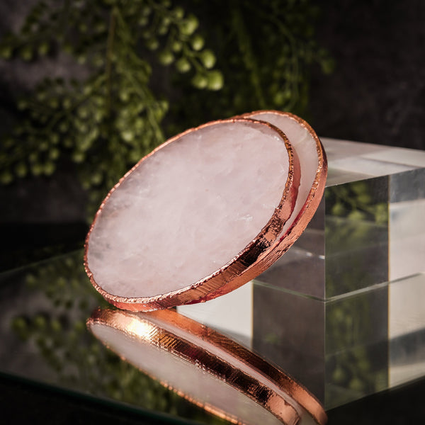 NIKITA natural rose quartz crystal coaster set of 2 to use for mugs and glasses in your home. A coffee table accessory with a rose gold gilded edge. Ideal christmas or new home gift for couples.