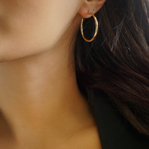 NIKITA classic, every day hoop earrings. Waterproof and hypoallergenic 18k plated hoops with a stainless steel base. Everyday jewellery gift for her.