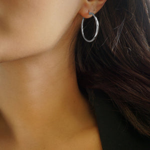 NIKITA classic, every day hoop earrings. Waterproof and hypoallergenic 18k plated hoops with a stainless steel base. Everyday jewellery gift for her.