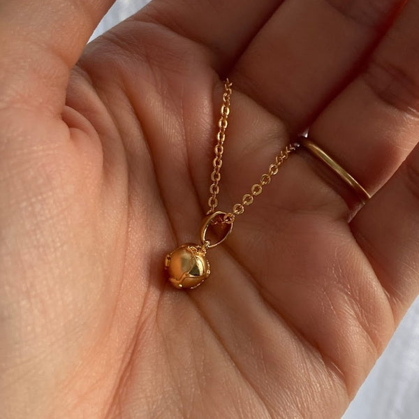 NIKITA globe pendant necklace with a unique, 3D earth design. A water-resistant world pendant with quality 18k gold plating and adjustable chain made with a hypoallergenic stainless steel base. Christmas everyday jewellery gift for her.
