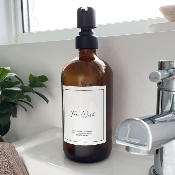 NIKITA amber glass dispenser bottle set with stainless steel pumps for your bathroom. Durable soap dispensers with waterproof labels for shampoo, conditioner and body wash. Ideal new home gift for her or gift for couple.