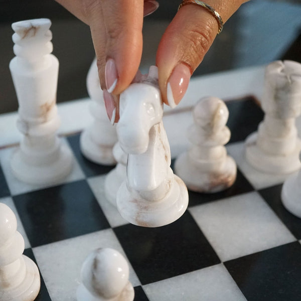 NIKITA Marble black and white monochrome chess board with 32 hand made pieces. A luxury gaming chess set that will also make a decorative homeware piece. Christmas or birthday gift for her or gift for couples.