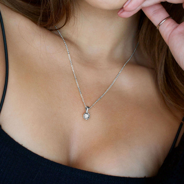 NIKITA globe pendant necklace with a unique, 3D earth design. A water-resistant world pendant with quality 18k gold plating and adjustable chain made with a hypoallergenic stainless steel base. Christmas everyday jewellery gift for her.