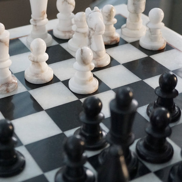 NIKITA Marble black and white monochrome chess board with 32 hand made pieces. A luxury gaming chess set that will also make a decorative homeware piece. Christmas or birthday gift for her or gift for couples.
