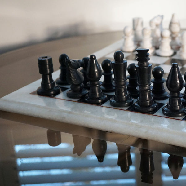 NIKITA Marble black and white monochrome chess board with 32 hand made pieces. A luxury gaming chess set that will also make a decorative homeware piece. Christmas or birthday gift for her or gift for couples.