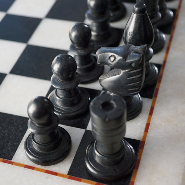 NIKITA Marble black and white monochrome chess board with 32 hand made pieces. A luxury gaming chess set that will also make a decorative homeware piece. Christmas or birthday gift for her or gift for couples.