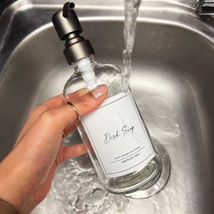 NIKITA clear glass dispenser bottle set with stainless steel pumps for your bathroom. Durable soap dispensers with waterproof labels for shampoo, conditioner and body wash. Ideal new home gift for her or gift for couple.