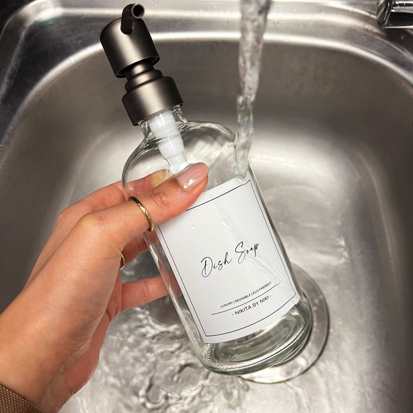 NIKITA clear glass dispenser bottle set with stainless steel pumps for your bathroom. Durable soap dispensers with waterproof labels for shampoo, conditioner and body wash. Ideal new home gift for her or gift for couple.